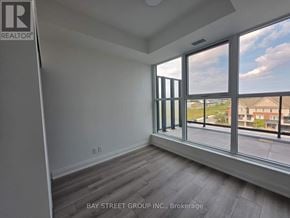 Toronto (Clairlea-Birchmount) condo for rent - A room with a large window overlooking a residential area.