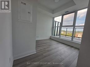 Toronto (Clairlea-Birchmount) condo for rent - A room with a window overlooking a parking lot.