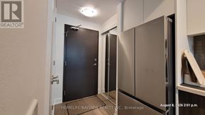 Toronto (Willowdale East) condo for rent - A kitchen with a black door and stainless steel appliances.