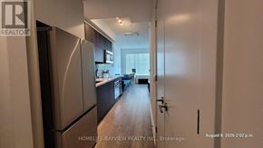 Toronto (Willowdale East) condo for rent - A kitchen with a refrigerator and wooden floors.