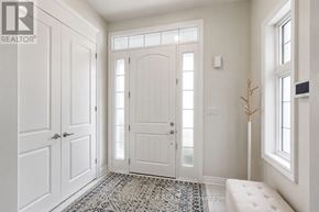Vaughan (Kleinburg) apartment for rent - A white hallway with a door and a bench.