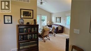 Nanticoke apartment for rent - A living room with a bookshelf, a chair, and a couch.