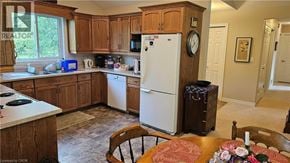 Nanticoke apartment for rent - A kitchen with wooden cabinets and a white fridge.