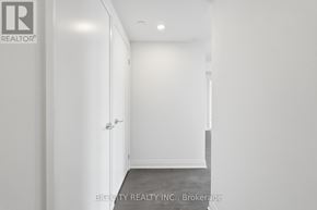 Toronto (Thorncliffe Park) condo for rent - A white hallway with a door on the left and a wall on the right.