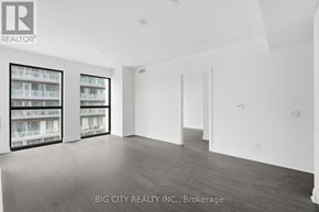 Toronto (Thorncliffe Park) condo for rent - A spacious room with a view of a balcony with a railing.