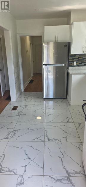 Toronto (West Hill) apartment for rent - A kitchen with a refrigerator and a counter.