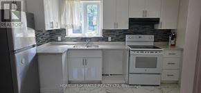 Toronto (West Hill) apartment for rent - A kitchen with white cabinets and appliances.