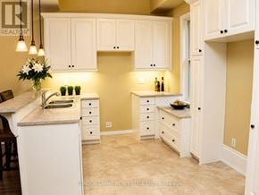 London South (South F) apartment for rent - A kitchen with white cabinets and a marble countertop.
