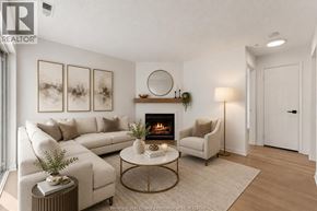 Windsor condo for rent - A living room with a fireplace and a couch.