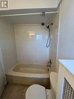 Toronto (Blake-Jones) condo for rent - A white bathroom with a tub, toilet and sink.