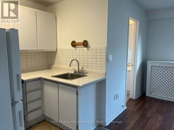 Toronto (Blake-Jones) condo for rent - A kitchen with white cabinets and a white counter top.