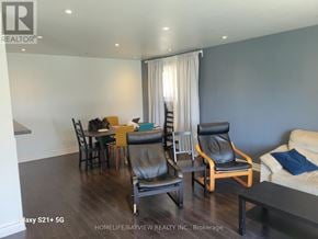 Toronto (York University Heights) apartment for rent - A living room with a dining table and chairs.