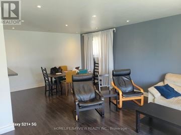 Toronto (York University Heights) apartment for rent - A living room with a dining table and chairs.