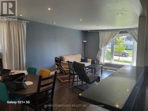 Toronto (York University Heights) apartment for rent - A living room with a couch, chairs, and a dining table.