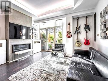 Toronto (Church-Yonge Corridor) condo for rent - A living room with a black couch and guitars on the wall.