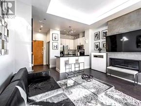 Toronto (Church-Yonge Corridor) condo for rent - A black and white living room with a glass coffee table in the middle.