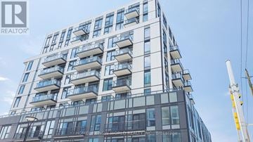 Toronto (Rouge) condo for rent - A tall building with many windows and balconies is under construction.