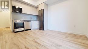 Toronto (Rouge) condo for rent - A kitchen with a stainless steel oven and a refrigerator.