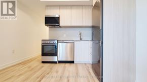 Toronto (Rouge) condo for rent - A modern kitchen with a stainless steel oven and white cabinets.