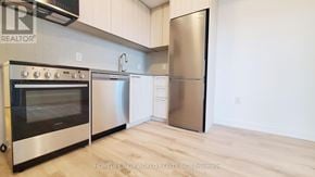 Toronto (Rouge) condo for rent - A modern kitchen with a stainless steel refrigerator and oven.