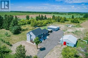 Amaranth apartment for rent - A realtor logo is on the top left corner of an aerial view of a property with a blue house, a red barn, and a tree.