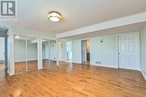 Amaranth apartment for rent - A spacious room with wooden floors and white walls.