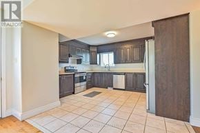 Amaranth apartment for rent - A kitchen with a tile floor and a wooden door.