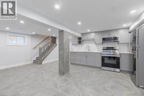 Hamilton apartment for rent - A spacious kitchen with a staircase leading to the upper floor.