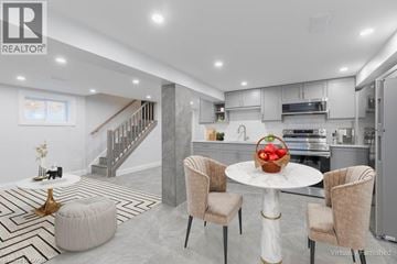 Hamilton apartment for rent - A modern kitchen with a dining table set in the middle.