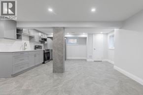 Hamilton apartment for rent - A spacious kitchen with grey cabinets and a marble pillar in the middle.
