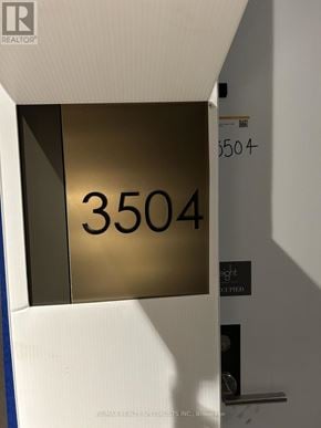 Toronto (Annex) condo for rent - A sign with the number 3504 on it is mounted on a wall.