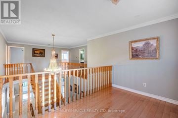 Mississauga (East Credit) apartment for rent - A living room with a staircase and a painting on the wall.