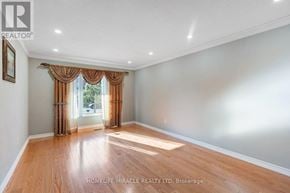 Mississauga (East Credit) apartment for rent - A room with wooden flooring and a window with curtains.