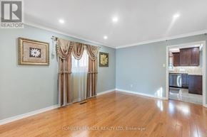 Mississauga (East Credit) apartment for rent - A room with wooden floors and a large window with curtains.