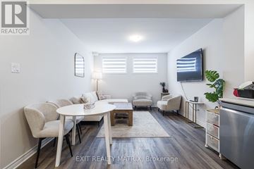 Ottawa apartment for rent - A modern living room with a dining table and chairs.