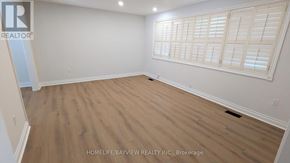Richmond Hill (Mill Pond) apartment for rent - A room with wooden flooring and white walls.