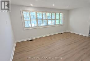 Richmond Hill (Mill Pond) apartment for rent - A room with a window and wooden flooring.