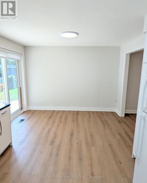 Richmond Hill (Mill Pond) apartment for rent - A room with wooden flooring and white walls.