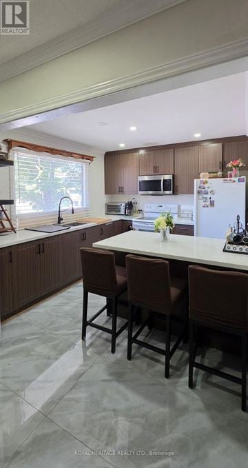 Mississauga (Streetsville) townhouse for rent - A kitchen with brown chairs and a white fridge.