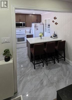 Mississauga (Streetsville) townhouse for rent - A kitchen with a table and chairs in the middle of the room.