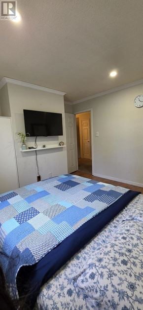 Mississauga (Streetsville) townhouse for rent - A bed with a blue and white comforter is in the foreground of the image.