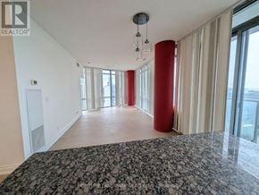 Toronto (Bay Street Corridor) condo for rent - A spacious room with a large bed and a view of the city.