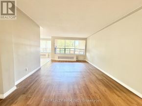London South (South F) condo for rent - A spacious room with wooden flooring and a window with blinds.