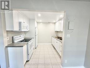London South (South F) condo for rent - A white kitchen with a microwave and oven built into the cabinetry.