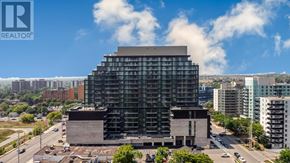 Mississauga (Cooksville) condo for rent - A large building with a glass facade is under construction in the city.