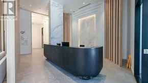 Mississauga (Cooksville) condo for rent - A reception area with a black counter and a marble wall.