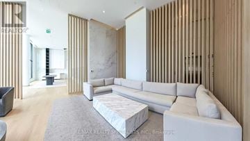 Mississauga (Cooksville) condo for rent - A modern living room with a white sofa and a grey rug.