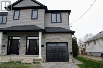 St. Catharines (Oakdale) apartment for rent - A two-story house with a garage door is for sale.