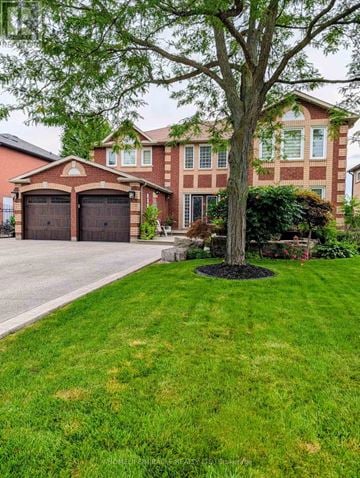 Caledon apartment for rent - A house with a red brick facade and a large tree in front.
