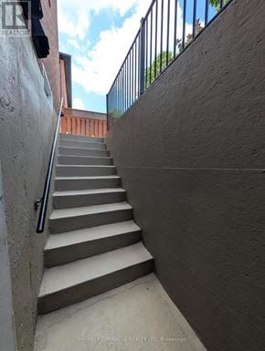 Caledon apartment for rent - A set of concrete stairs with a metal railing on the side.